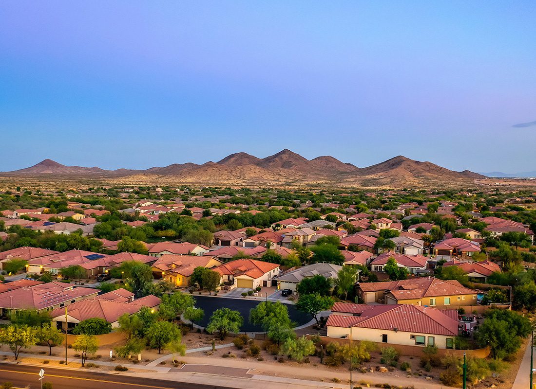 Phoenix, AZ - Aerial View of Phoenix Homes With Mountains in the Background